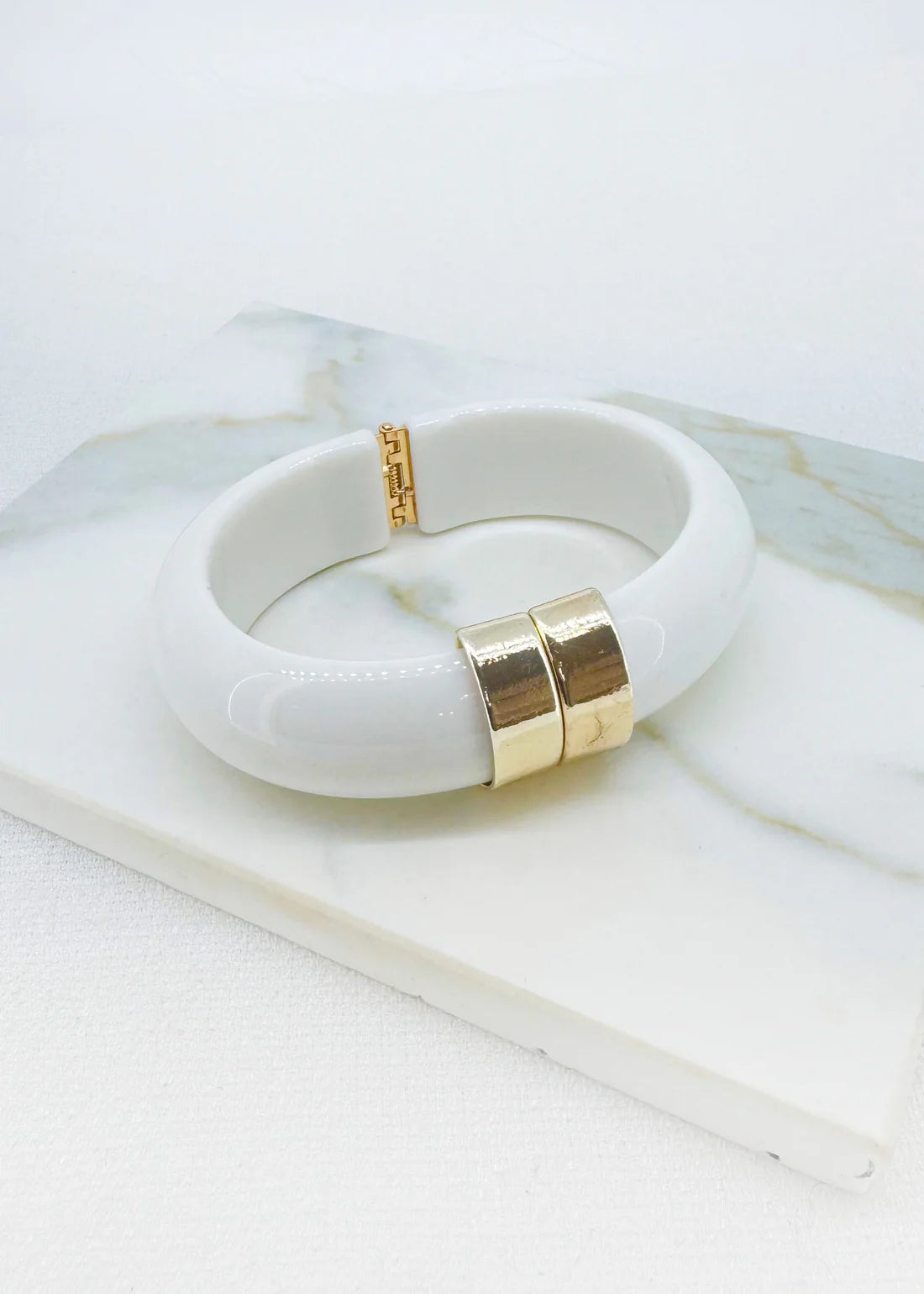 Envy Chunky white resin bracelet with gold‑tone accents with a spring hinged opening