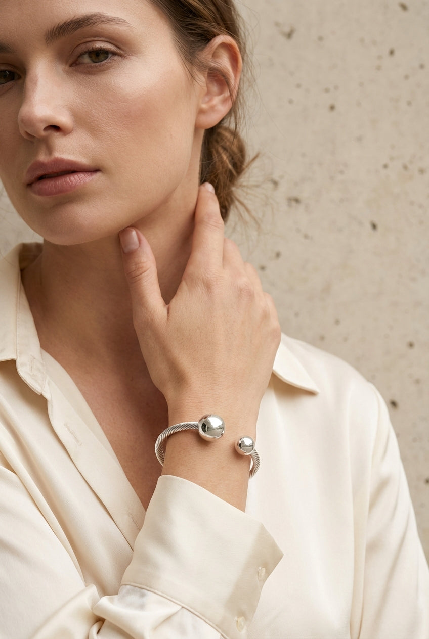 Envy Silver open‑cuff bracelet with twin polished sphere ends and a twisted band