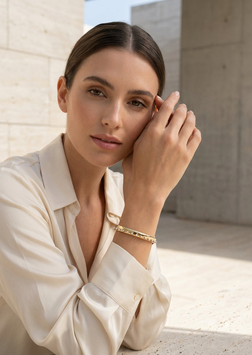 Envy Gold slim cuff bracelet with a sleek band edged in evenly spaced silver spheres