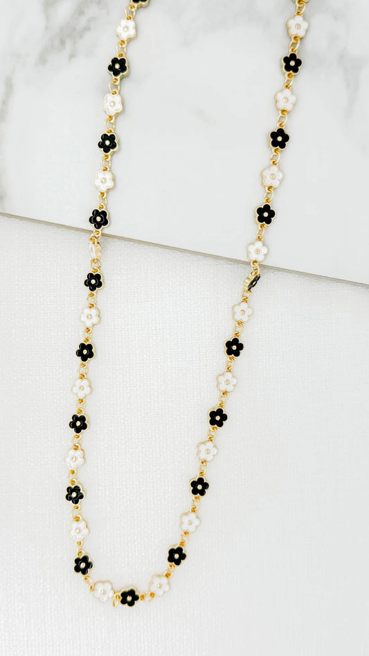 Envy Long gold necklace with black and white enamel daisy design