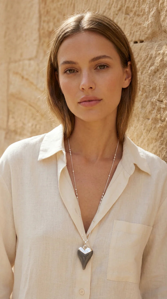 Envy Delicate silver chain with gold beads and a grey heart pendant.