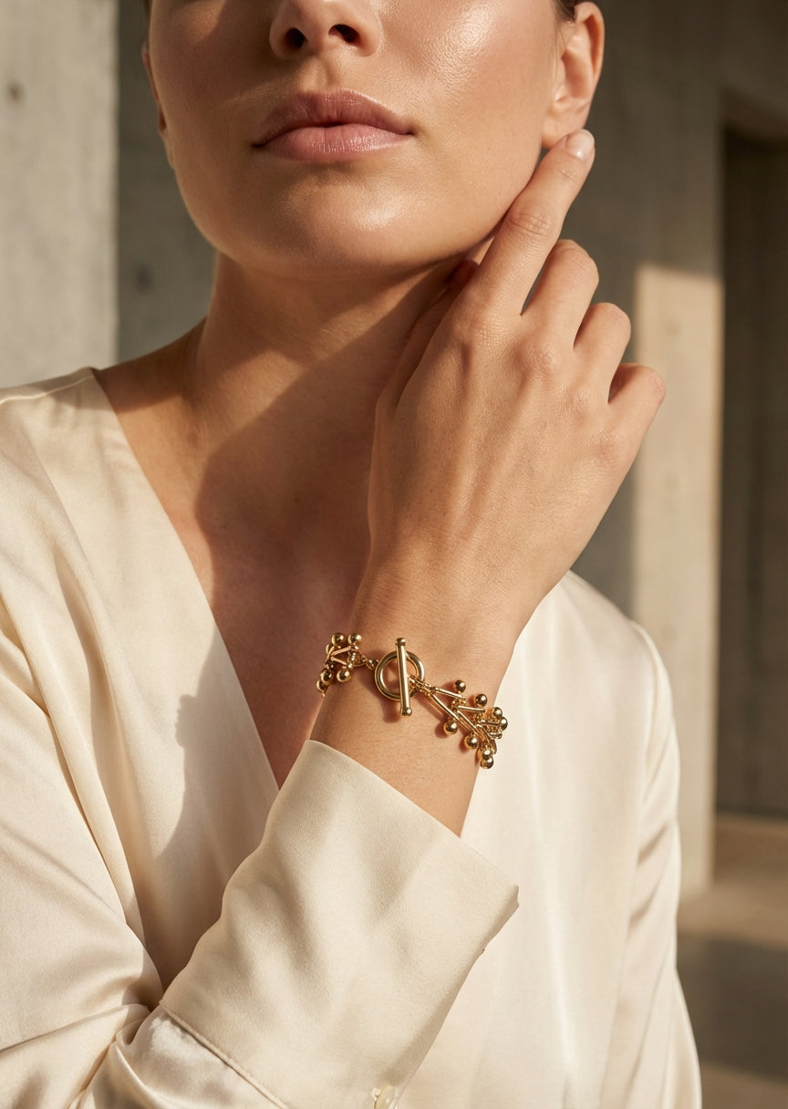 Envy Gold cluster‑bead bracelet with a decorative toggle clasp