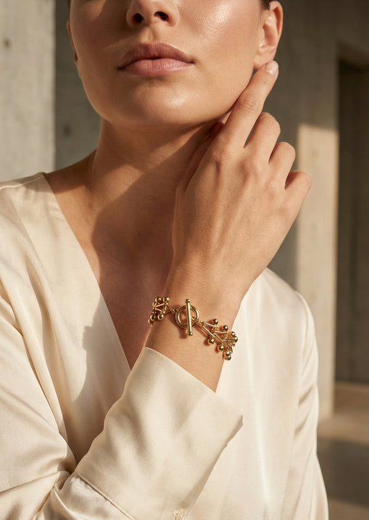 Envy Gold cluster‑bead bracelet with a decorative toggle clasp