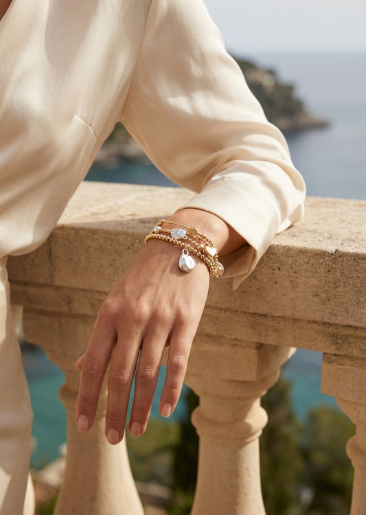 Envy Gold charm‑stack bracelet featuring silver and gold beads