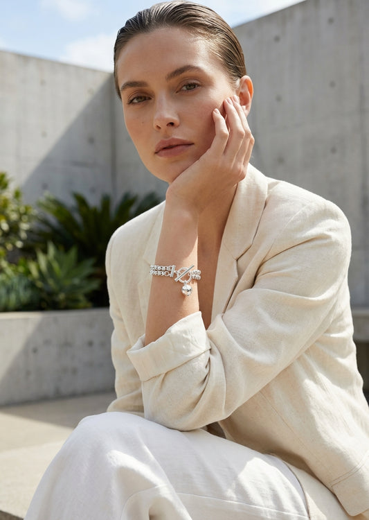 Envy Silver linked bracelet with ball charm and a decorative toggle clasp