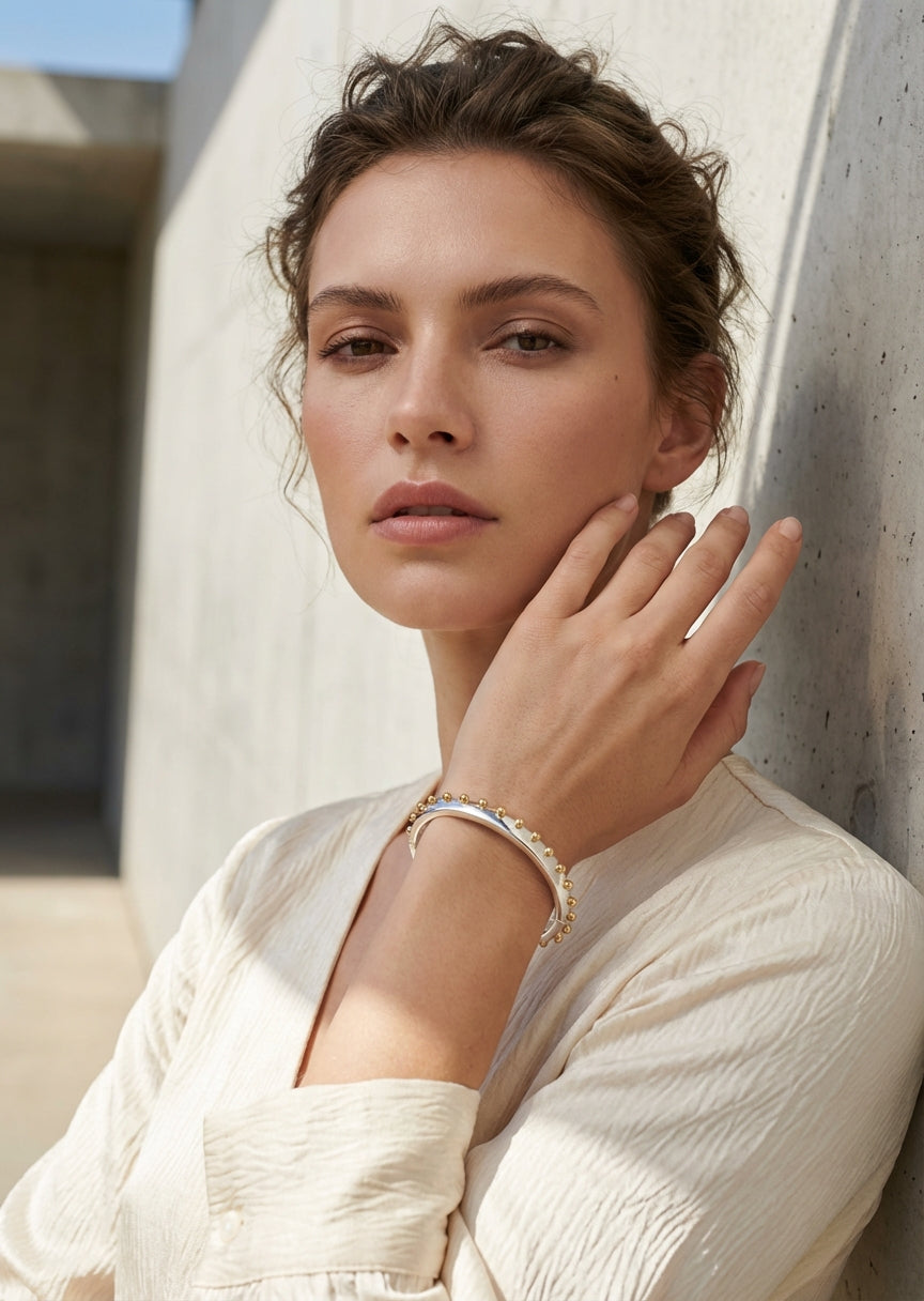 Envy Silver slim cuff bracelet with a sleek band edged in evenly spaced gold spheres
